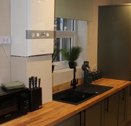 A kitchen with sink and cabinets at Blackburn Heights Apartment 1 in Bridlington