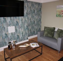 A living room with a sofa and a coffee table at Cornerhouse Apartment 1 in Llandudno