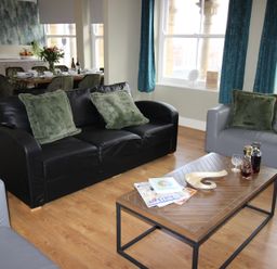 A living room with a coffee table and sofa at Cornerhouse Apartment 1 in Llandudno
