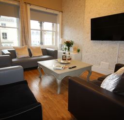 A living room with seating and a television at Cornerhouse Apartment 3 in Llandudno