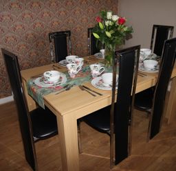 A dining room with a table set for meal at Cornerhouse Apartment 5 in Llandudno