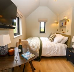 A bedroom with bed and television at 2 West Dunkirk Neuk in Hexham