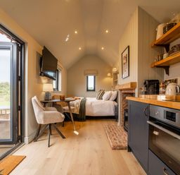 A studio room with a bed, kitchen area, and dining table at 2 West Dunkirk Neuk Humshaugh