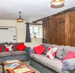 A living room with sofas and a coffee table at The Cheese House near Charmouth