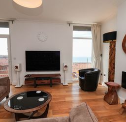 A living room with a television and sofa at 26 Metropole Towers in Whitby