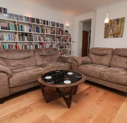 A living room with a sofa and coffee table at 26 Metropole Towers in Whitby