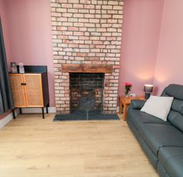 A living room with a fireplace and sofa at Portobell House in Bridlington