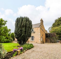 A house with trees and a garden at Prudhoe Cottage in Prudhoe