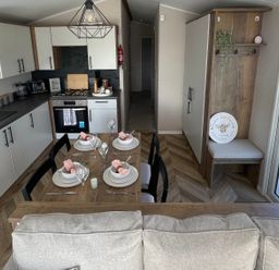 A kitchen with a dining table and chairs at Unity Beach in Burnham-on-Sea
