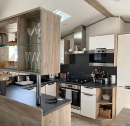 A kitchen with various appliances and storage at Findhorn Lodge Peaceful Sleeps 4 in Forres