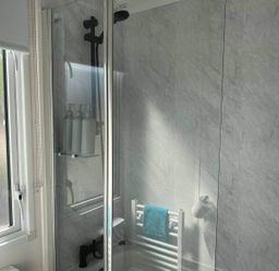 A shower with a towel rail and window at Findhorn Lodge Peaceful Sleeps 4 in Forres