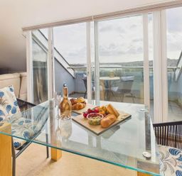 A dining area with a glass table and food at Apartment Sleeps 4 Enclosed Garden Pets Welcome in Flushing