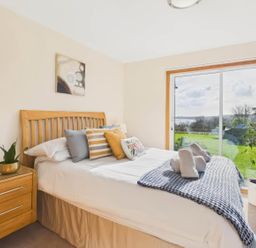 A bedroom with bed and nightstand at Apartment Sleeps 4 Enclosed Garden Pets Welcome in Flushing