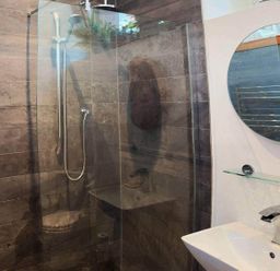 A bathroom with a shower, sink, and mirror at Old Chapel of Ermington Converted Vestry in Ermington