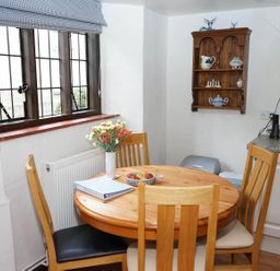 A kitchen with a round table and chairs at a property