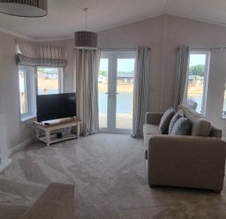 A living room with a television and sofa at Pet Friendly 2Bed Luxury Lodge in Routh HotTub near Heron Lakes Luxury Lodge Park