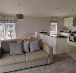A living room with a sofa, table and chairs at Pet Friendly 2Bed Luxury Lodge in Routh HotTub Heron Lakes Luxury Lodge Park near Beverley
