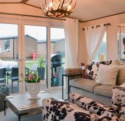 A living room with a sofa and coffee table at Boutique lodge with hot tub sleeps 6 in Bridlington