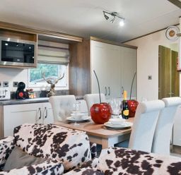 A kitchen with a dining area at Boutique lodge with hot tub sleeps 6 in Bridlington