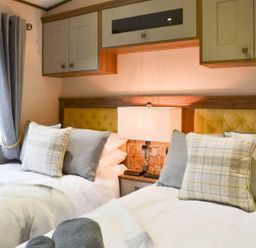 A bedroom with two beds and a lamp at Boutique lodge with hot tub sleeps 6 Bridlington