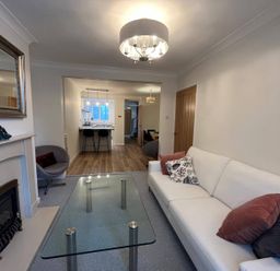 A living room with a sofa and coffee table at Charming 3Bed Cottage Private Garden Parking in Torquay