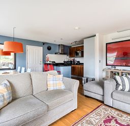A living room with a sofa and dining area at 2bed sleeps4 pool freeparking Trenythonestate Near Par