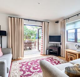 A living room with a sofa and television at 2bed sleeps4 pool freeparking Trenythonestate Near Par