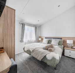 A bedroom with a bed and bedside table at Atlantic Breeze Luxury Lodge sleep 6 Mullacott near Ilfracombe