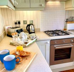 A kitchen with a toaster, kettle, and breakfast items at Stunning Sleeps 6 Luxury Lodge Pets Mercia Marina near Willington, Derbyshire