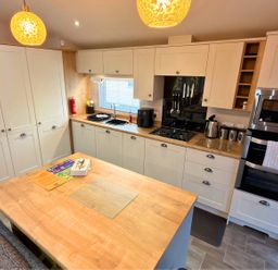 A kitchen with cabinets and countertop at Meadows 33 Hot tub Southview Holiday Park Skegness