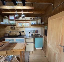 A kitchen with a sink and fridge at the property in an unspecified location