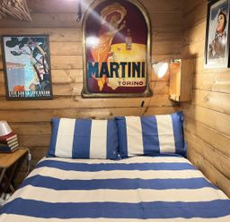 A bedroom with a bed and wall art at The Old Barn in Manchester