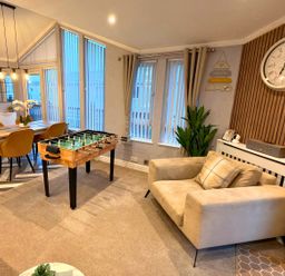 A living room with a foosball table and dining area at The Old Barn in Manchester