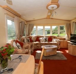 A living room with a sofa and television at Leven in Lampeter