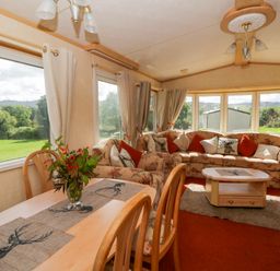 A snug with a sofa and dining table at Leven in Lampeter