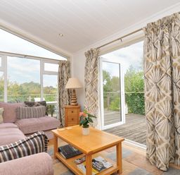A living room with a sofa and coffee table at 5 Tree Tops in Dobwalls