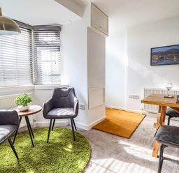 A living room with chairs and a table at 1 Glanaber Terrace