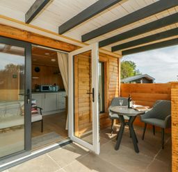 An outdoor area with a table and chairs at Oak Lodge Brecon
