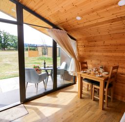 A dining room with a table and chairs at Sycamore Lodge Brecon