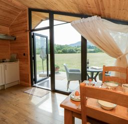 A kitchen with a table and chairs at Sycamore Lodge in Brecon