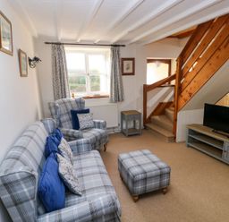 A living room with seating and a television at The Stable in Haverfordwest