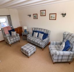 A living room with sofas and an ottoman at The Stable in Haverfordwest