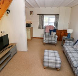 A living room with a sofa and television at The Stable in Haverfordwest