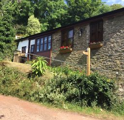 A building with stone wall and flower boxes at The Old Forge Hallsands