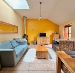 A living room with a sofa and coffee table at The Old Forge in Hallsands