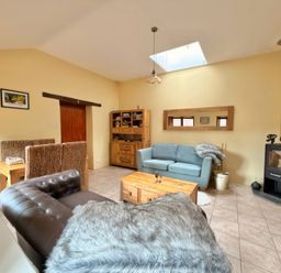 A living room with a sofa and coffee table at The Old Forge in Hallsands
