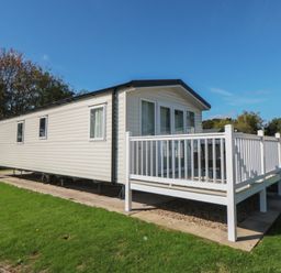 A mobile home with a deck at 14 Pines in Cayton Bay