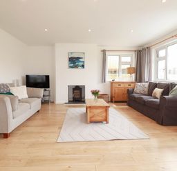 A living room with a sofa and a coffee table at Cloudbreak in Wadebridge