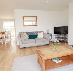 A living room with a sofa and coffee table at Cloudbreak in Wadebridge