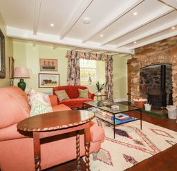 A living room with a sofa and coffee table at The Homestead 